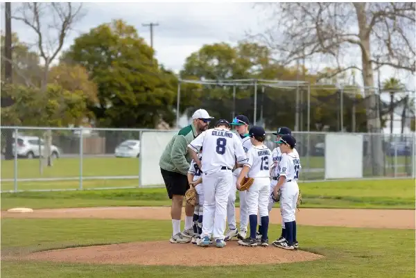 Coach Myles Berniard-Mendez leading a youth baseball training session in Long Beach