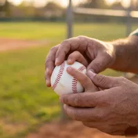 Close-up of Coach Myles demonstrating a baseball grip